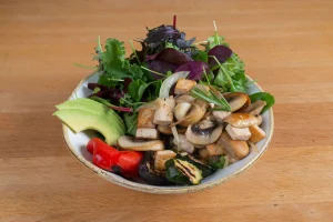 "Vegan tofu bowl with quinoa, avocado, sautéed mushrooms, onion and rosemary – served at LIT Coffee Bar, Berlin."